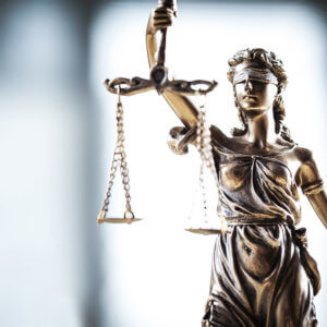 Lady Justice holding scales | Savoy Investigations